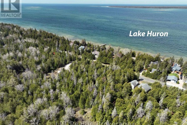 Top-down view of 9-acre wooded lot with snow, bordered by Spry Shore Road and nearby homes. - Pt Lt 24 Spry Shore Road, Northern Bruce Peninsula