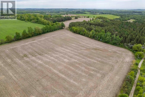 Overcast sky with scattered clouds above a verdant, hilly landscape. - Pt Lt 6 Con 6 7th Line, Port Hope
