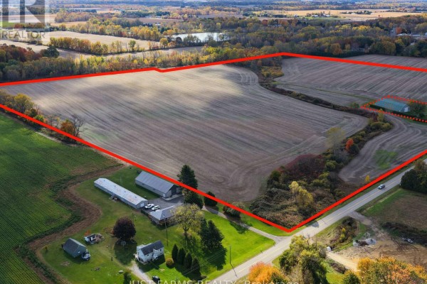 Aerial view of the farm property with agricultural outbuildings, fields, and a rural road along the edge. - Pt Lt 8 Queens Line, West Elgin