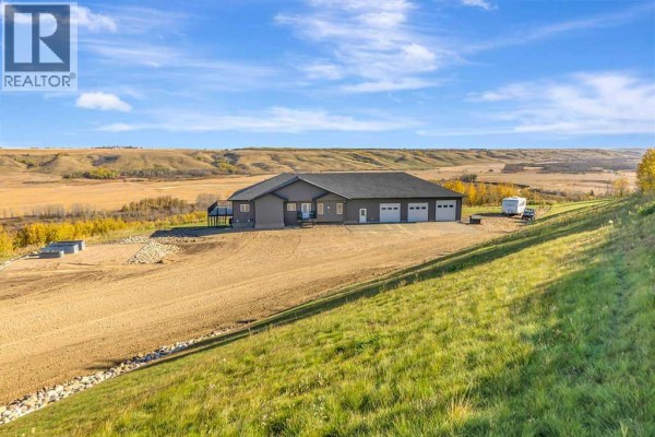 View of the grey house from a grassy hill with fields and a river in the distance. - Pt Nw 8-45-1-w4, Rural Wainwright No  61, M D  Of
