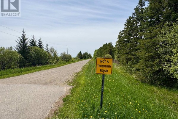 View of a gravel road with a 'Not a Through Road' sign and surrounding greenery. - Ptlt 20 Con 8 (9th Line), Amaranth