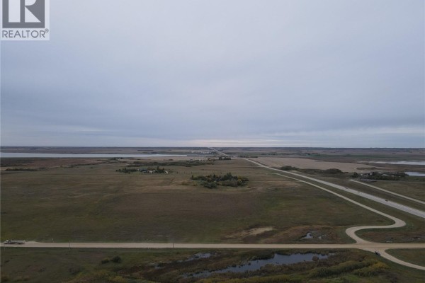 Expansive view of rural land with a highway, roads, fields, and water. - Rm Of Blucher Land, Blucher Rm No  343