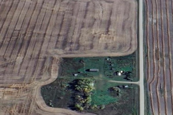 View of the property from further out, highlighting the rural setting and buildings. - Rm Of Buchanan Acreage, Buchanan Rm No  304