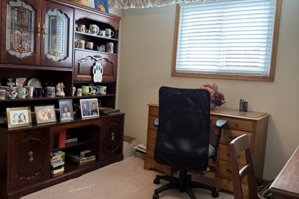 Home office with a large wooden hutch, a desk, an office chair, and a window with blinds. - Room - 28 Orangewood Crescent, Toronto