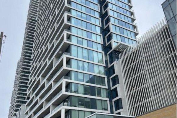 Close-up exterior view of a contemporary apartment building with glass and white concrete details. - Shared Unit 3107 - 898 Portage Parkway, Vaughan