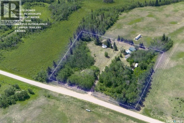 A light blue building with a white roof has a wooden porch and steps. - Shell Lake Private Trailer Park, Canwood Rm No  494