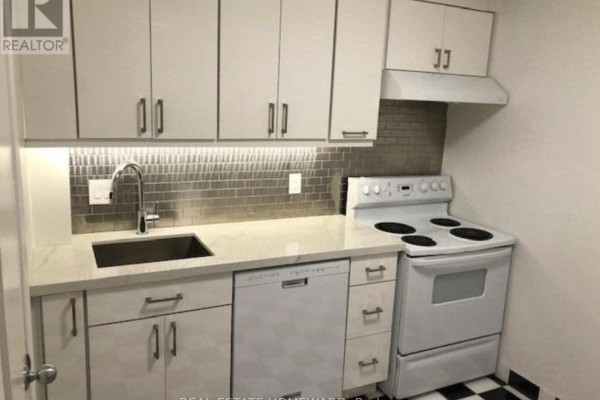 Compact kitchen with white cabinets, stainless steel appliances, and tiled backsplash - Side - 274 Rumsey Road, Toronto