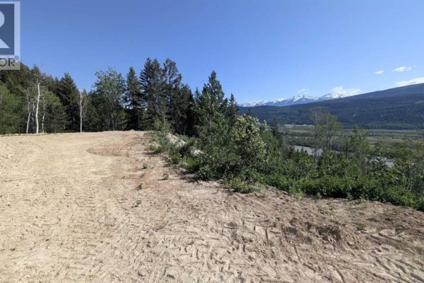 Cleared, sandy building site with distant snow-capped mountains and trees. - Site #15, 3483 Highway 95, Out Of Province_alberta