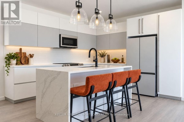 Modern kitchen with a white quartz island, grey and white cabinets, and stainless steel appliances. - Sky Residence - Sugar Ridge Condos Valley Road, Antigua