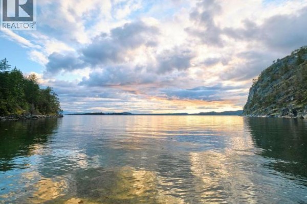 View of a wide calm bay with reflections of a cloudy sunset sky on the water. - Sl 18 Sarah Point Road, Powell River