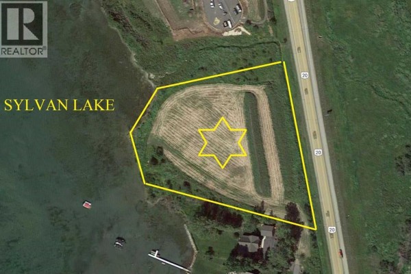 Aerial view showing a large, cleared lot adjacent to Sylvan Lake, outlined in yellow with a star marking. - South Of Twin Fawn Subdivision, Jarvis Bay