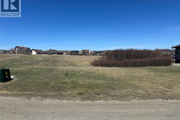 Empty lot with scattered green utility box and distant houses. - Sundale Lot, Mckillop Rm No  220