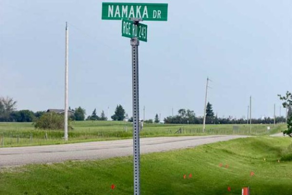 Green street sign indicating Namaka Drive and Rge Road 243 with a paved road. - Tbd Namaka Drive, Namaka