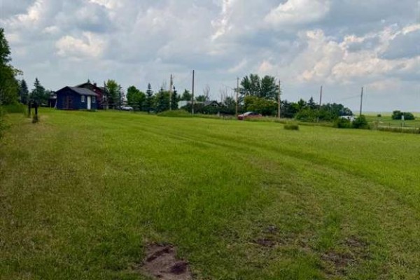 View of a large, green, open field with a small dark blue shed and houses in distance. - Tbd Namaka Drive, Namaka