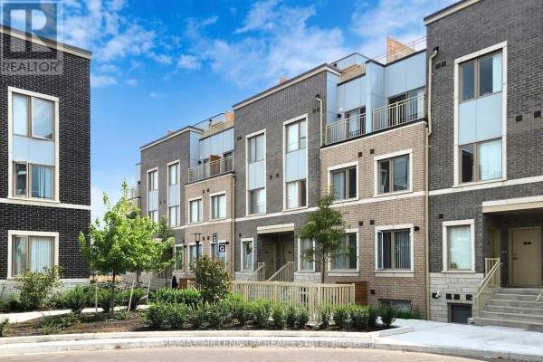 Street view of a row of modern brick townhouses with trees and landscaping. - Th 350 - 100 Honeycrisp Crescent, Vaughan