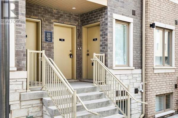 Close-up of townhouse entrances with beige doors, railings, and brick exterior. - Th 350 - 100 Honeycrisp Crescent, Vaughan