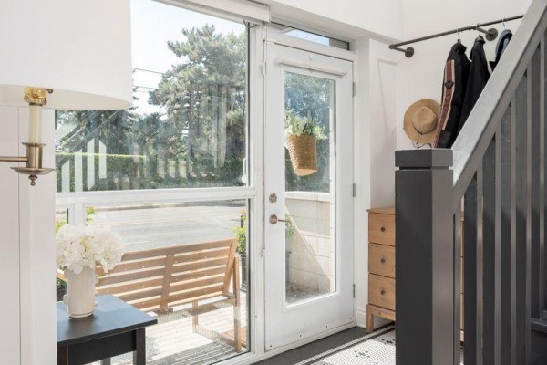 View from entryway showing glass doors, street, bench, and porch. - Th10 - 1350 Kingston Road, Toronto