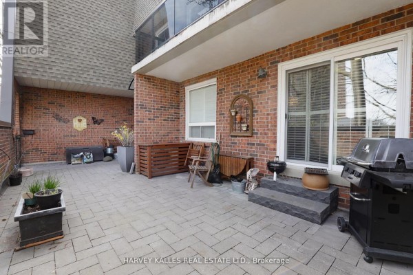 Patio area with brick flooring, seating, and barbecue grill - Th16 - 18 La Rose Avenue, Toronto