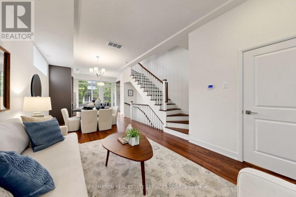 View of the living room, dining area, and white staircase in a townhouse. - Th17 - 88 Sheppard Avenue E, Toronto