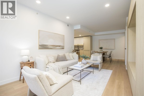 Living room and dining area with light wood finishes and neutral decor. - Th201 2471 St. George Street, Vancouver