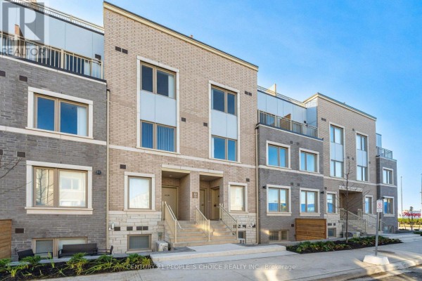 Front view of a townhouse with beige and grey brick, two entrances, and balconies. - Th263 - 150 Honeycrisp Crescent N, Vaughan