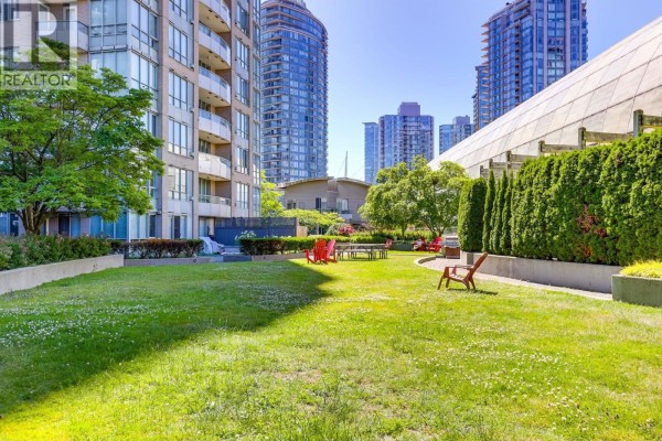 Indoor swimming pool and hot tub area with blue tiled flooring and lounge chairs. - Th3 63 Keefer Place, Vancouver