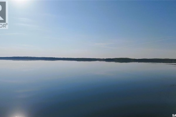 Expansive view of Iroquois Lake under a bright blue sky with calm water. - The Woodlands, Iroquois Lake
