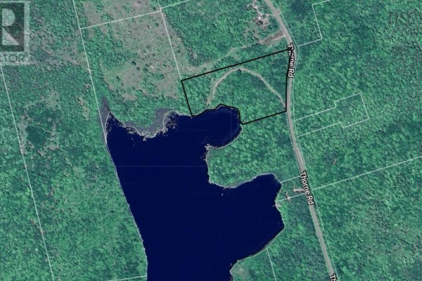 Scenic view of a shimmering lake with trees along the shoreline. - Thorne Road, West Dalhousie