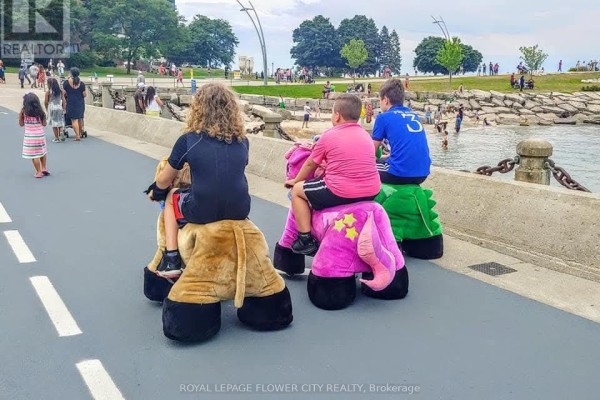 Children riding colorful stuffed animals along a waterfront path - Tt35 - 13850 Steeles Avenue W, Halton Hills