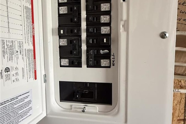 Close-up of an open electrical panel with multiple circuit breakers. - Turtleford Acreage., Mervin Rm No 499