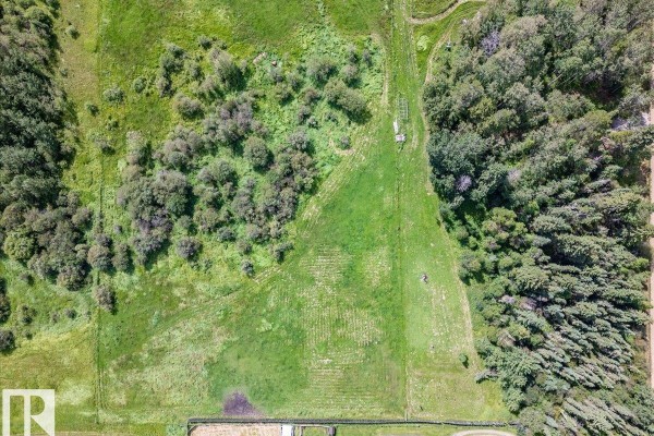 Overhead view of a green pasture with scattered trees and a long, narrow clearing. - Twp Rd 452a Rr 15, Rural Wetaskiwin County