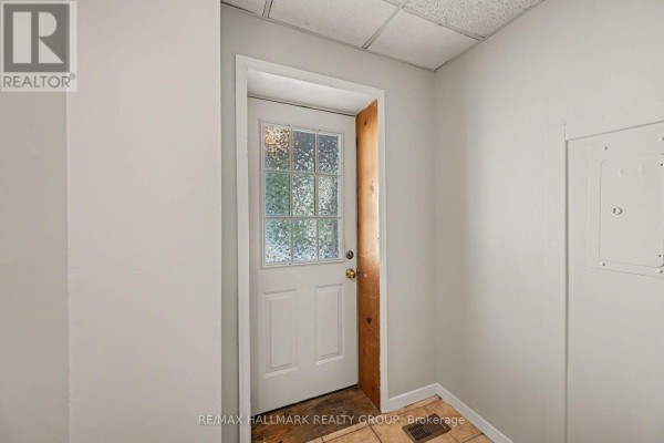 Interior view of a small entryway with a white door and frosted glass window. - Unit 1 - 216 Bell Street, Arnprior