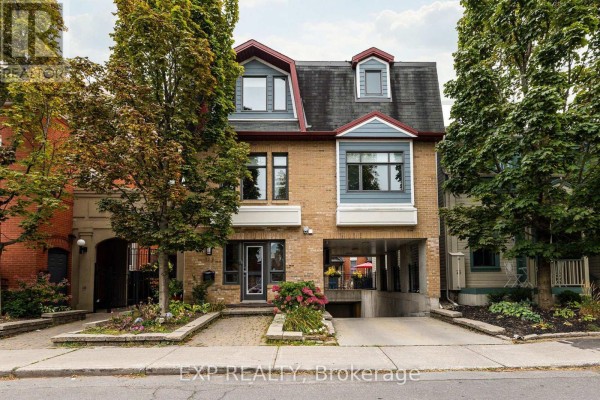 Exterior view of a brick building with a pitched roof and dormer windows. - Unit 1 Level 1 - 122 Guigues Avenue W, Ottawa