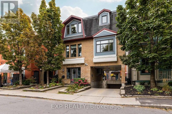 Front exterior of a multi-story brick building with a pitched roof. - Unit 1 Level 1 - 122 Guigues Avenue W, Ottawa
