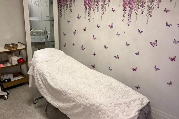 Treatment room with massage table and floral wallpaper accents - Unit 10 - 10610 Bayview Avenue, Richmond Hill