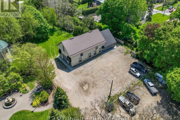 Aerial view of the property showing ample parking space and surrounding trees. - Unit #3 - 12 Leggett Lane, Kincardine