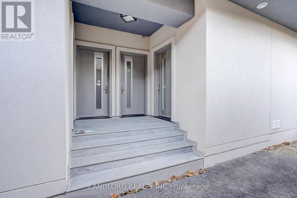 Front entrance with three doors and a set of stone stairs. - Unit 4 - 1344 Pape Avenue, Toronto
