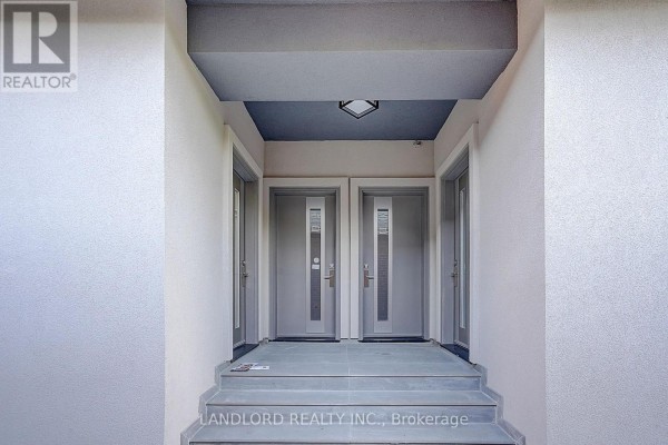 Covered entryway with three doors and overhead lighting. - Unit 4 - 1344 Pape Avenue, Toronto