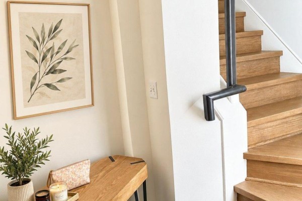 Wooden console table with artwork and plant next to a staircase. - Upper - 10496 Islington Avenue, Vaughan