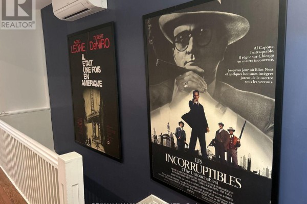 Hallway with dark blue walls, white railing, and movie posters, including The Untouchables. - Upper - 18 Pape Avenue, Toronto