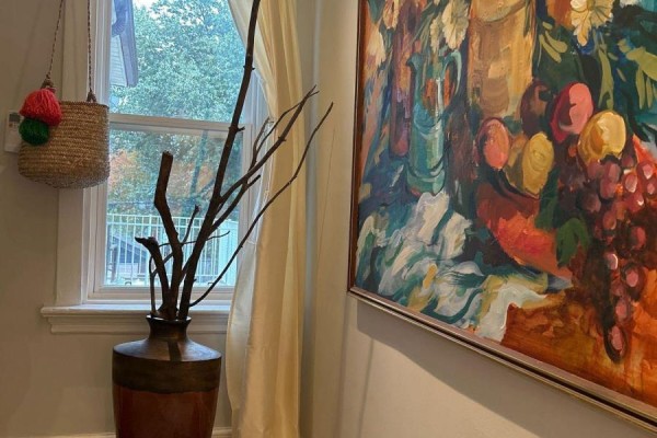 Close-up of a vase with branches, a woven bag, and a window with light curtains. - Upper - 18 Pape Avenue, Toronto