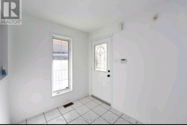 Front view of the house showcasing architectural details and snow on the ground - Upper - 24 Hayloft Court, Brampton