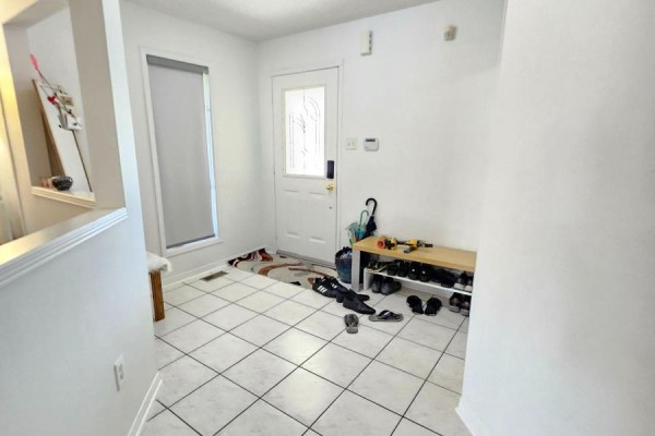Entryway with white walls, tiled floor, and a window beside the front door - Upper - 24 Hayloft Court, Brampton