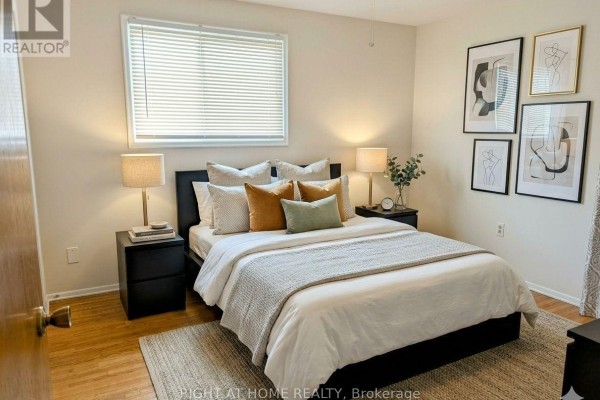 Bedroom with a queen-size bed, two nightstands, lamps, and artwork on the wall. - Upper - 30 San Remo Drive, Hamilton