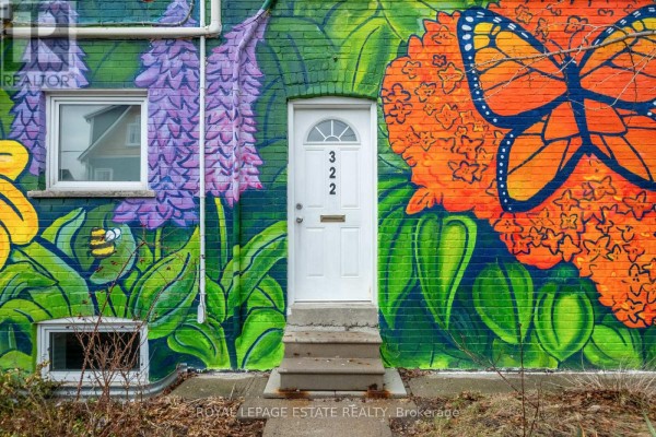 Close-up of a mural on the rear exterior, featuring flowers, a butterfly, and two white doors. - Upper - 322 Silver Birch Avenue, Toronto