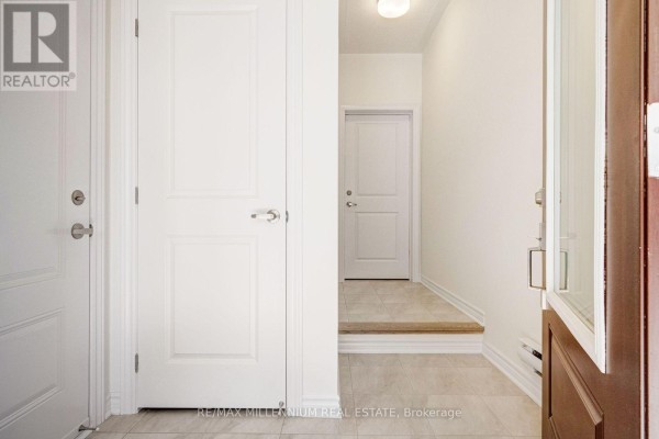 Interior entryway with beige tile floor, white doors, and a step up to a hallway. - Upper - 34 Thornbird Crescent, Brampton