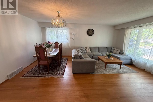 Living and dining area with a formal dining set, large sectional sofa, and hardwood floors. - Upper - 35 Melville Crescent, Brampton