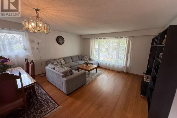 Combined living and dining room featuring a large L-shaped sofa, dining table, and hardwood flooring. - Upper - 35 Melville Crescent, Brampton