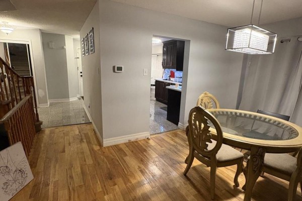 View from the dining room looking towards the staircase and a doorway into the kitchen. - Upper - 36 Beaumont Drive, Ajax