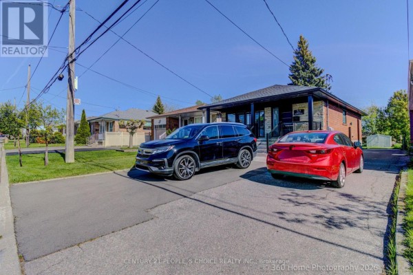 Front exterior of a detached bungalow with a paved driveway and front porch. - Upper - 37 Bentworth Avenue, Toronto